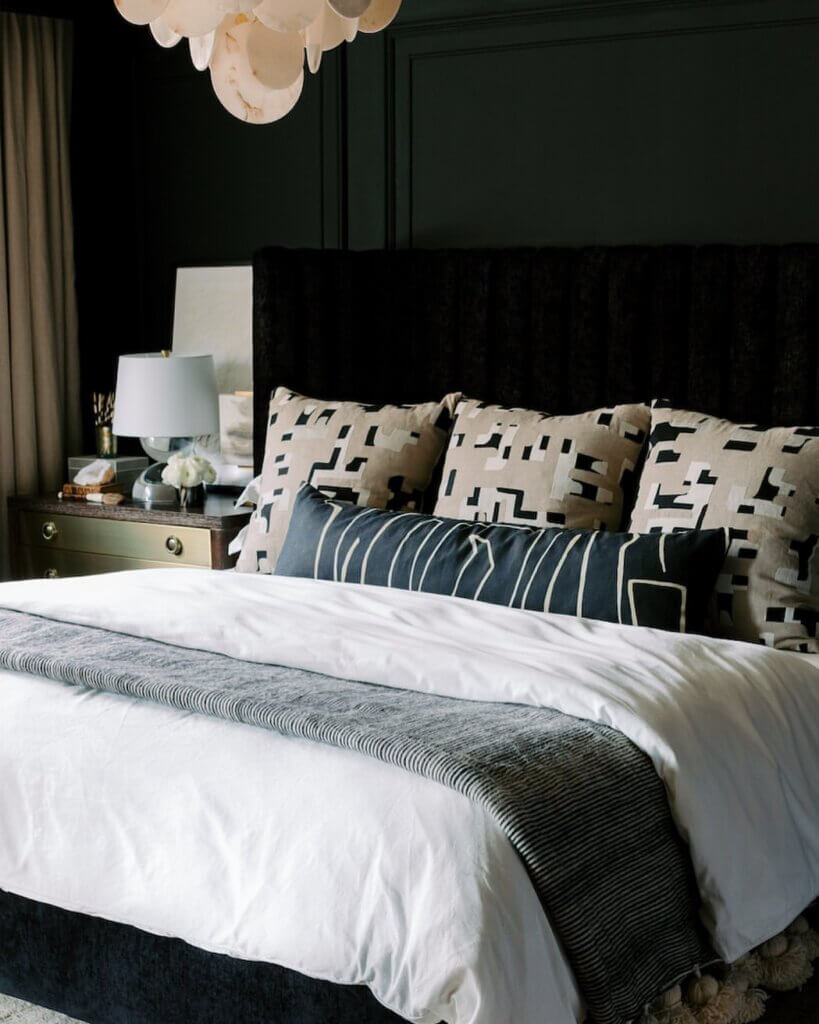 A bedroom featuring a black accent wall