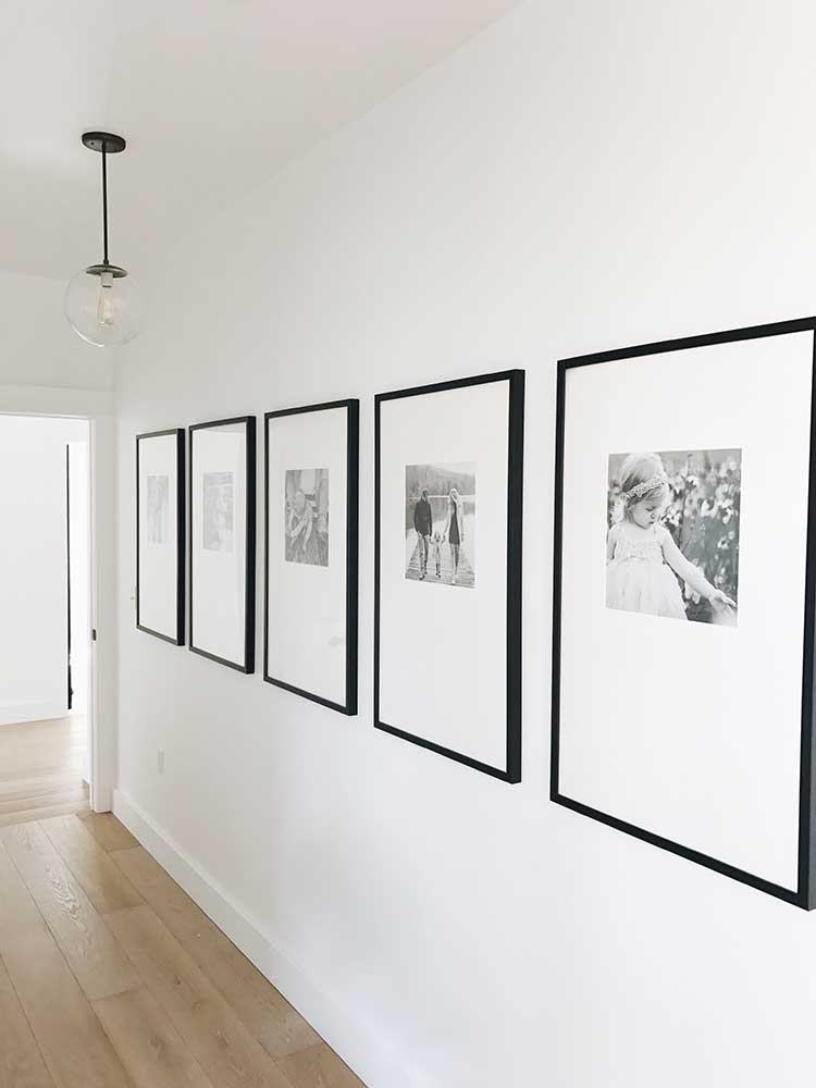 Black frames hanging in hallway