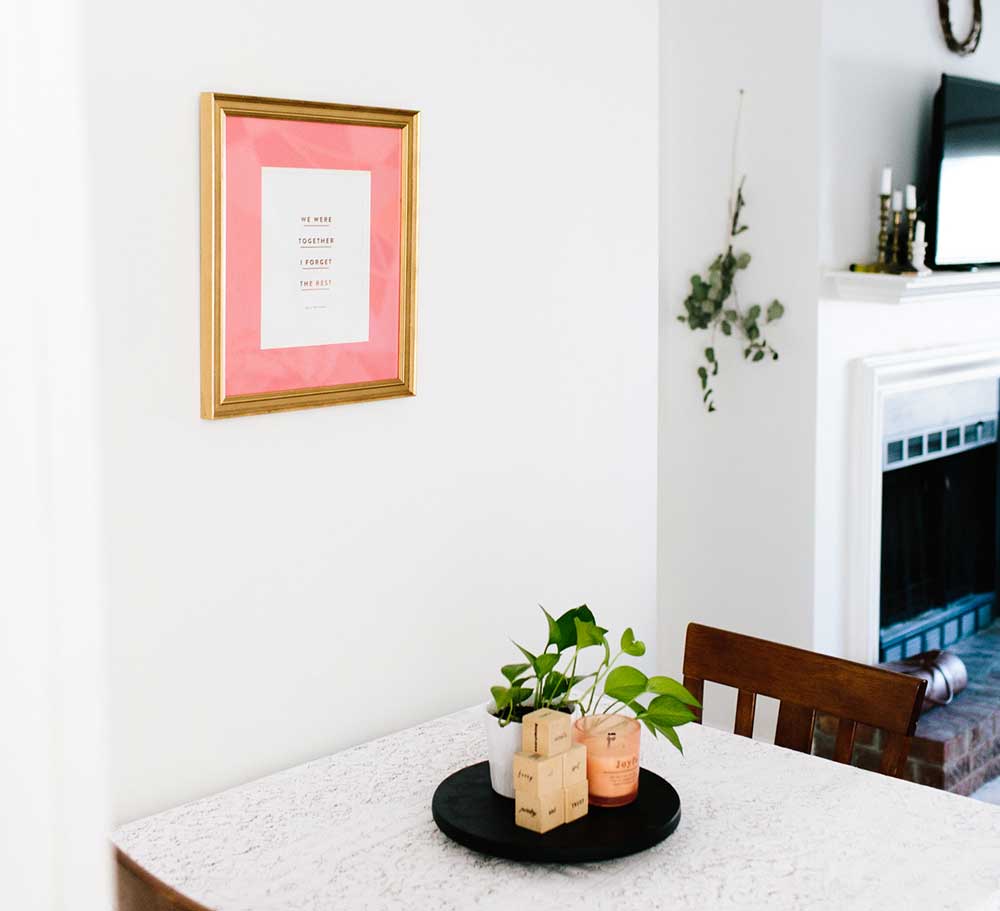 Kitchen table with frame on wall